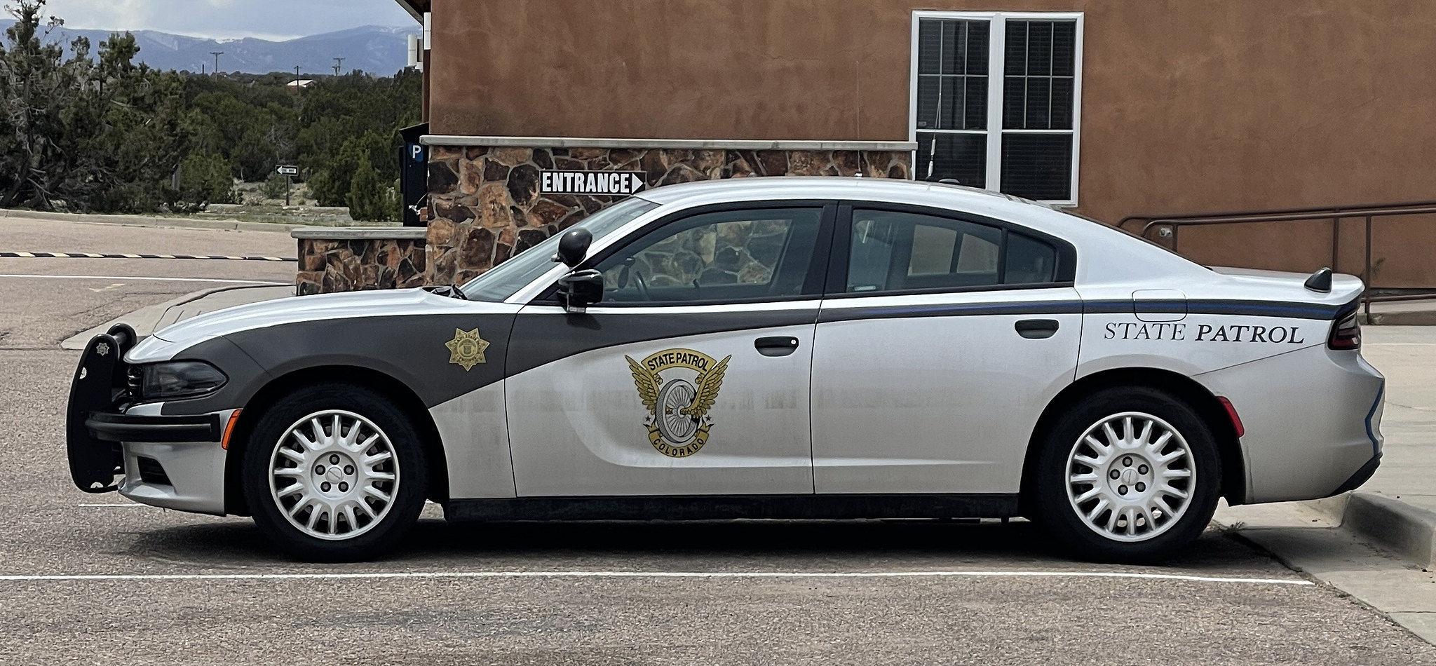 Photo of Colorado State Patrol car in front of brick building
